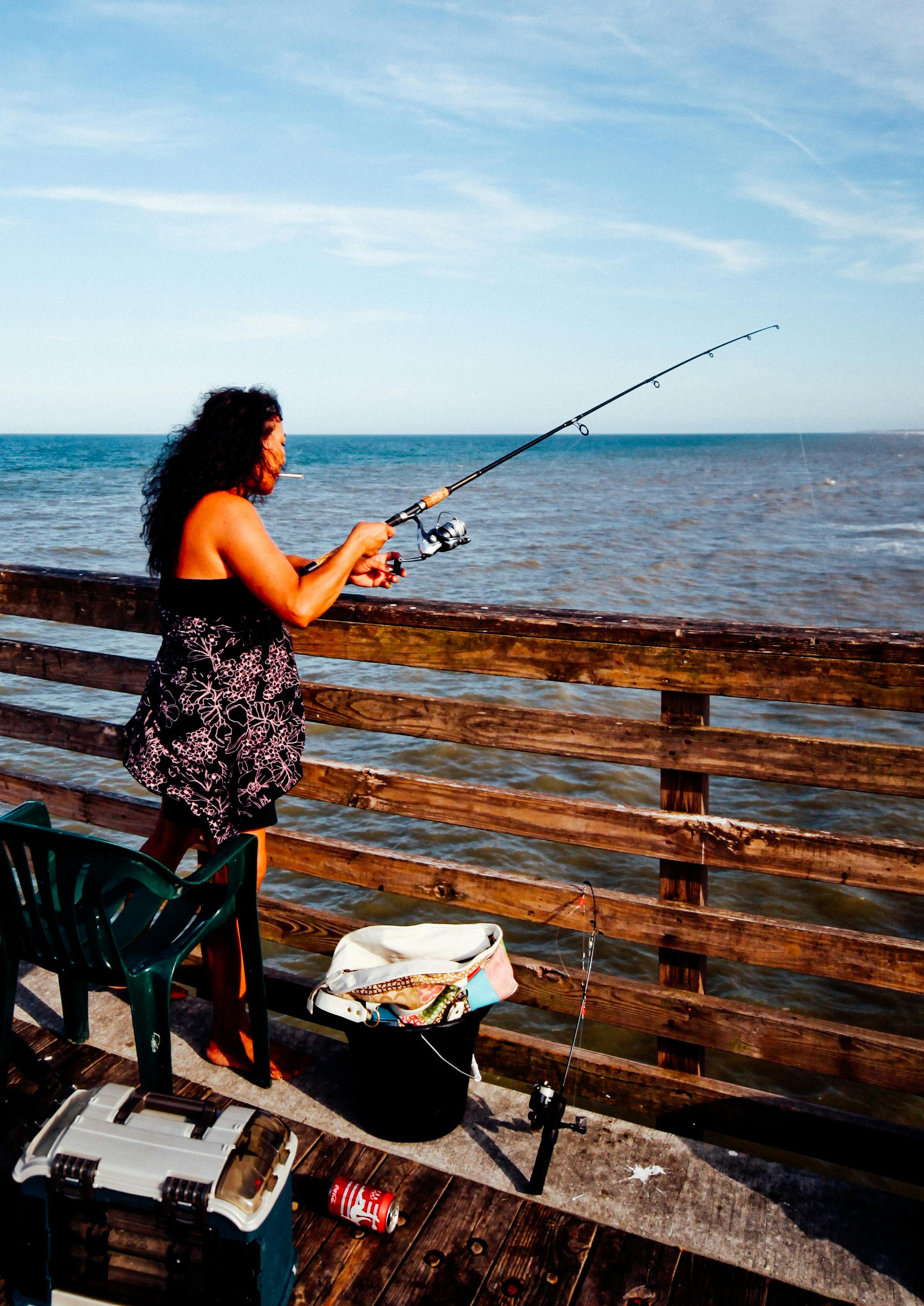 photo of woman using fishing rod