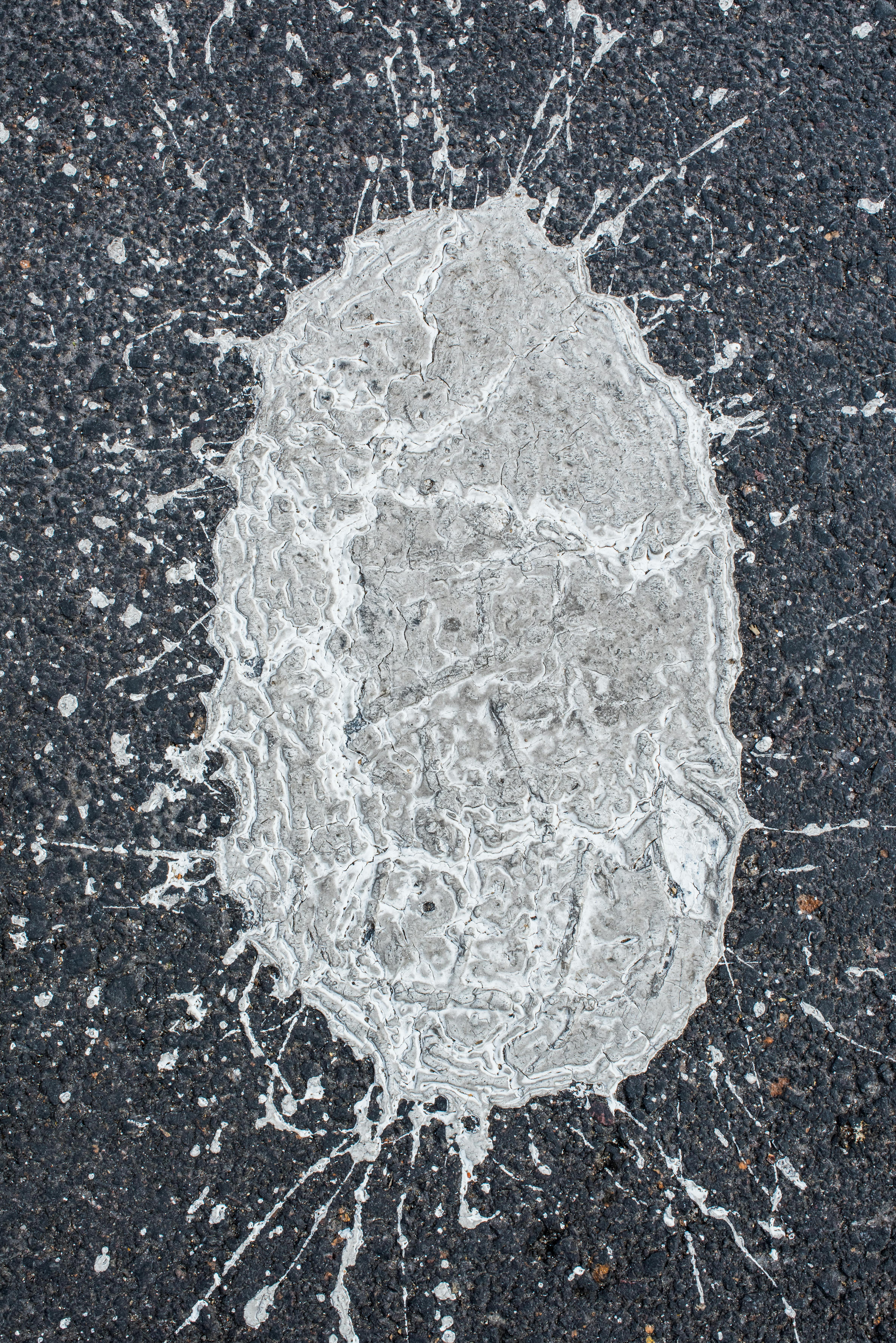 Abstract Splash Pattern on Pavement Surface · Free Stock Photo