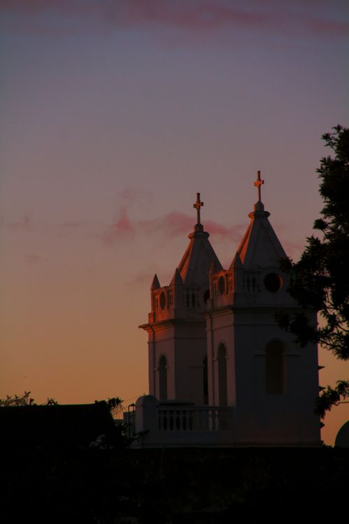 Free Beautiful silhouette of Asilah's church towers against a colorful sunset sky in Morocco. Stock Photo