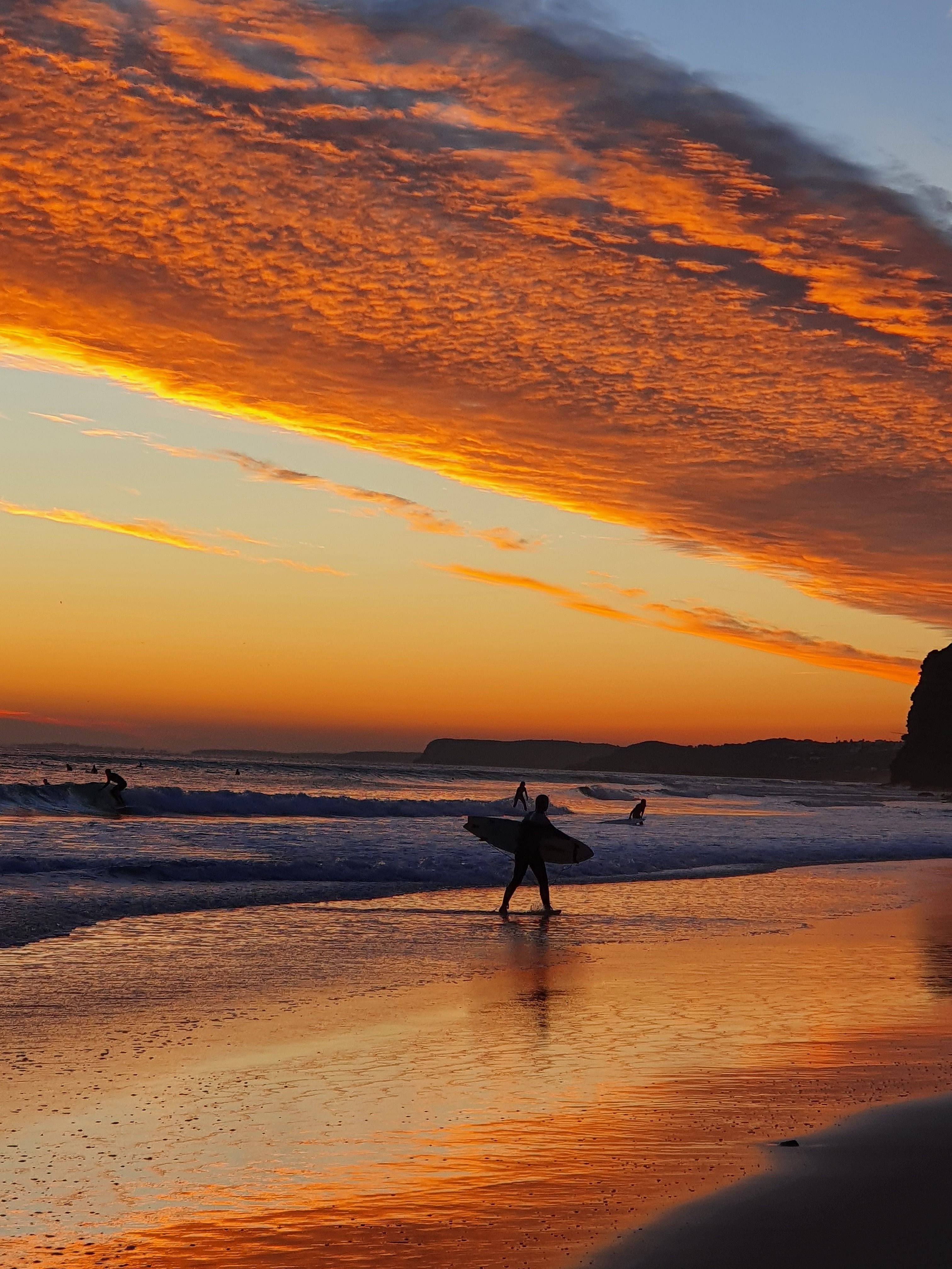 Surfer Silhouette at Sunset on Ocean Beach · Free Stock Photo