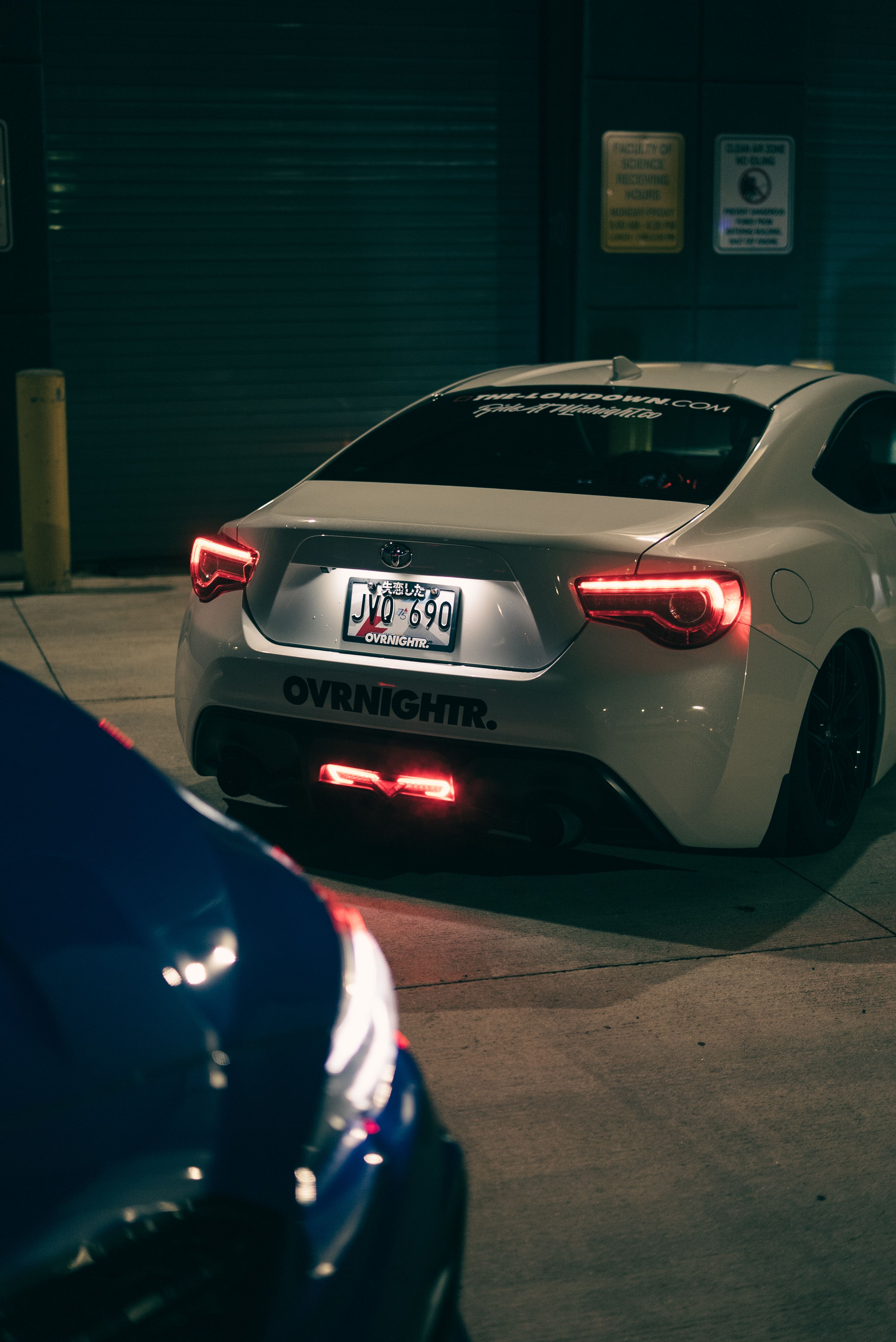 Night Street View of Sports Car Rear in Urban Setting · Free Stock Photo
