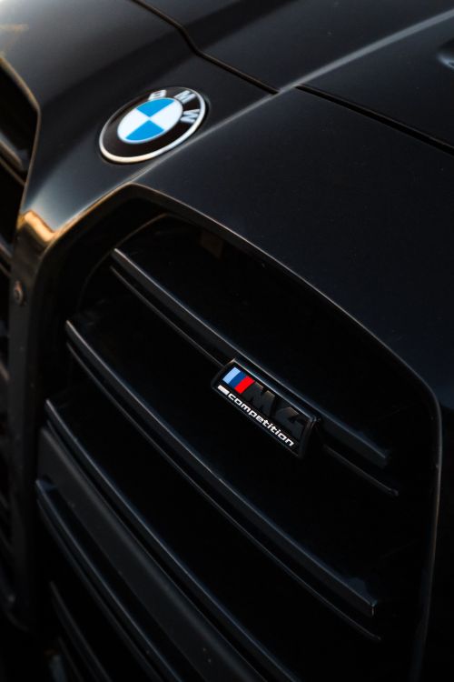 Free Detailed view of a sleek black car grille and emblem showing luxury design. Stock Photo