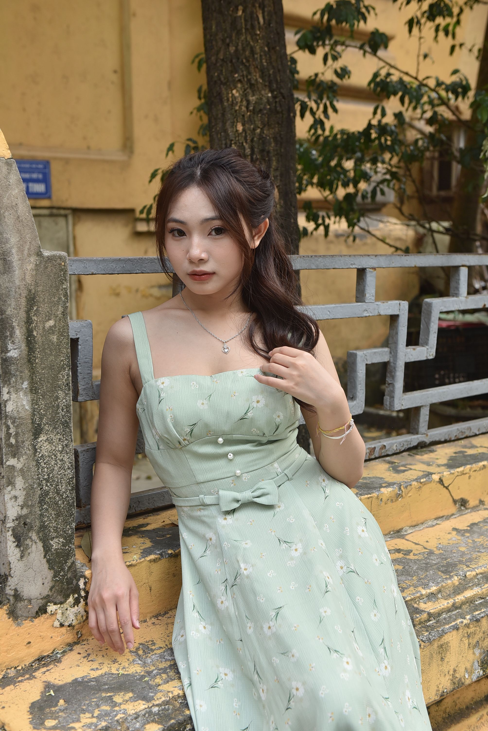Woman Posing Outdoors in Elegant Floral Dress · Free Stock Photo