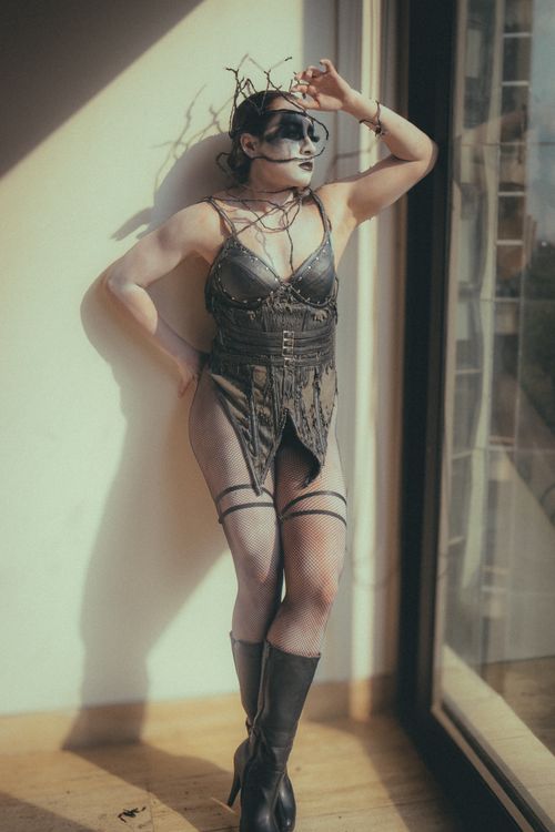 Free Stylish Halloween-inspired portrait with edgy costume and makeup. Natural lighting enhances the artistic vibe. Stock Photo