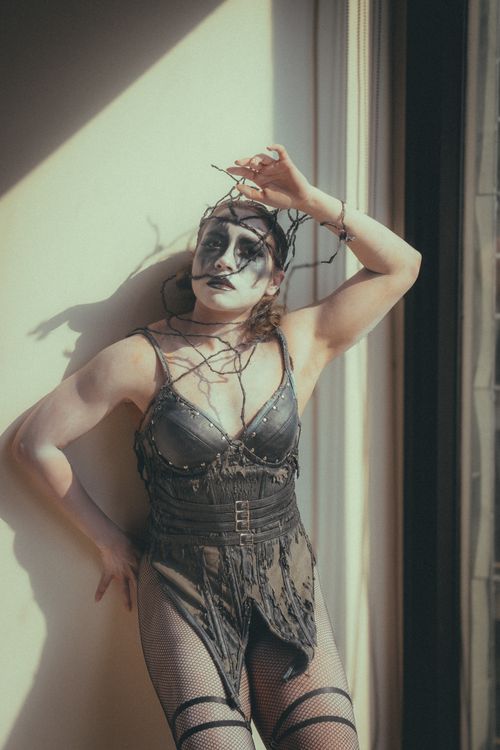 Free Spooky Halloween-themed portrait with creative makeup and costume in urban setting. Stock Photo
