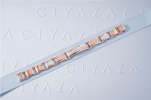 Sleek rose gold jewelry elegantly displayed on a Ciyaza embossed surface, perfect for fine jewelry enthusiasts.