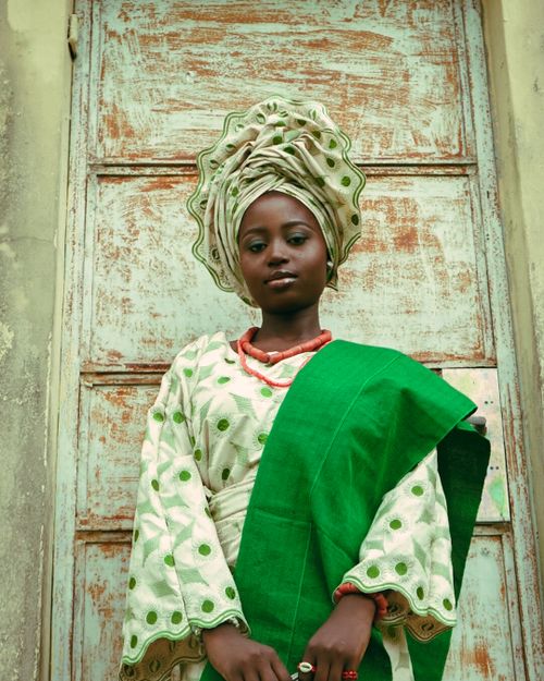 Free Portrait of a young African woman in traditional attire, standing confidently. Stock Photo