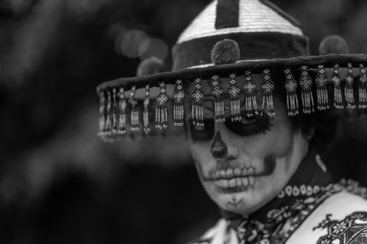A striking portrait of Catrina makeup in Mexico City's vibrant cultural celebration.