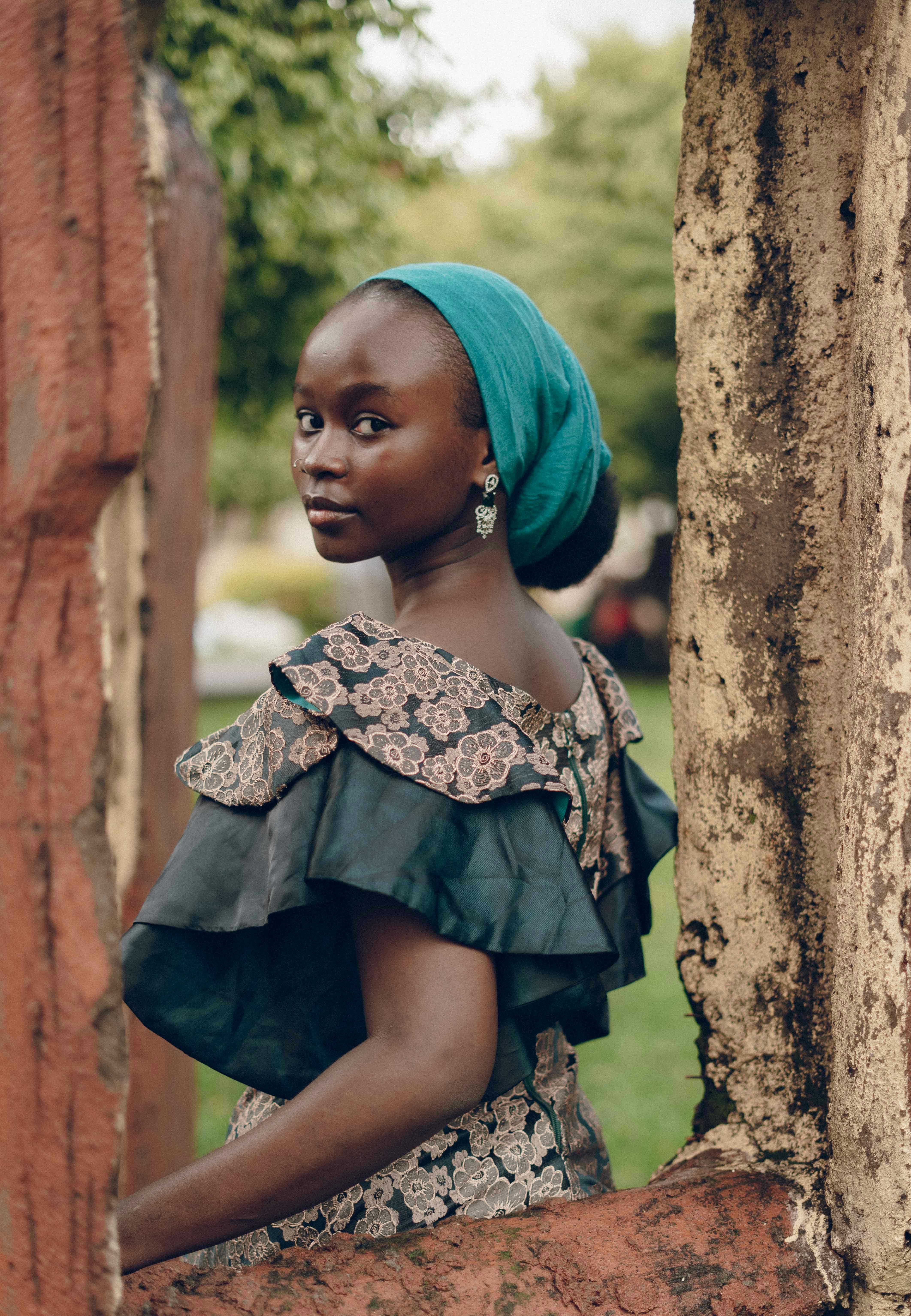 身着鲜艳服饰的尼日利亚女子在户外优雅地摆姿势，捕捉文化之美