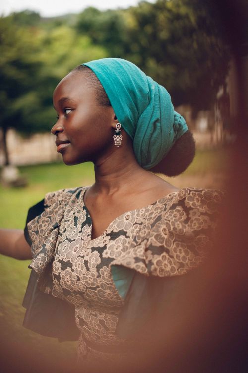 Free Beautiful Nigerian woman in traditional attire, captured outdoors with vibrant colors and serene expression. Stock Photo