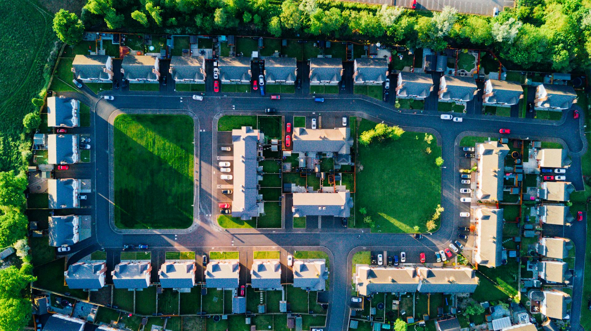 Vibrant aerial view of residential area in Ireland with houses and greenery.