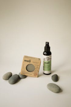 Minimalist setup featuring natural skincare products with pebbles, ideal for eco-friendly themes.