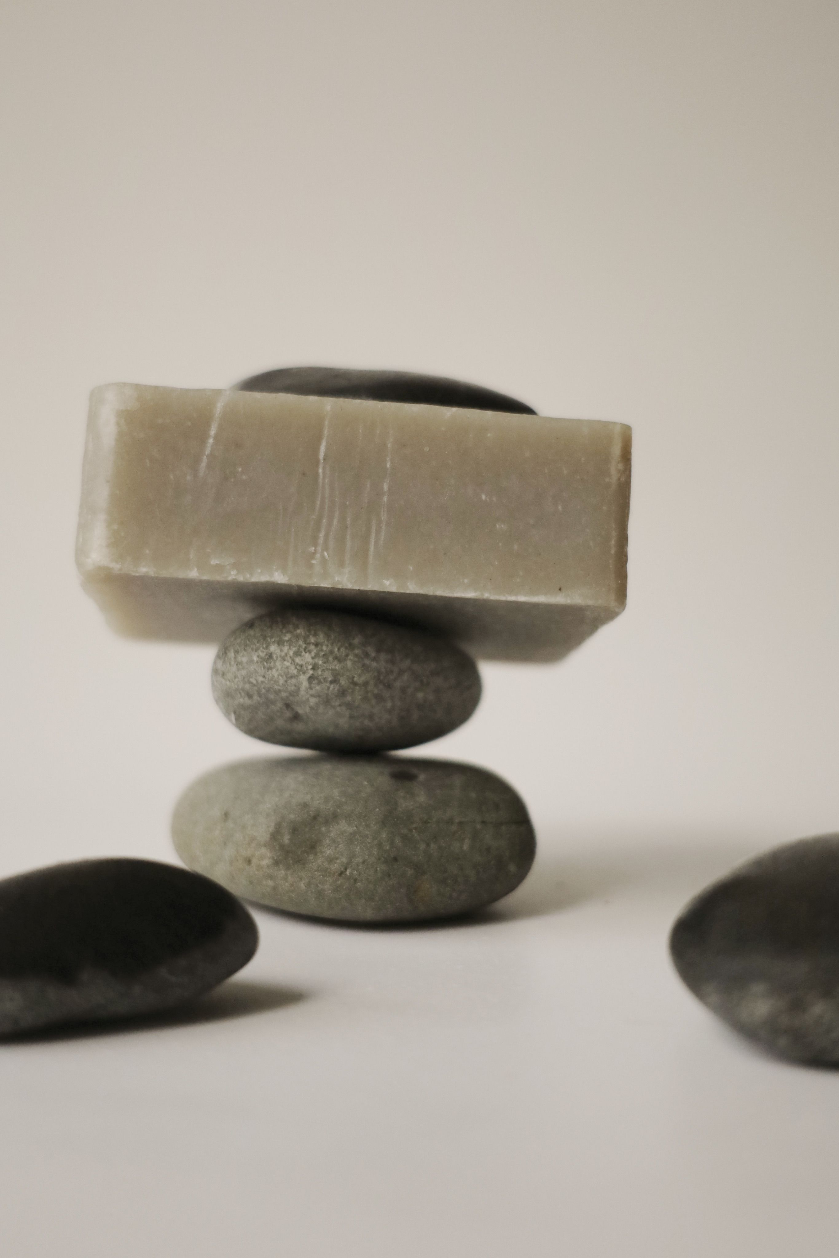 A soothing arrangement of stones balanced with a soap bar, perfect for spa-themed projects.