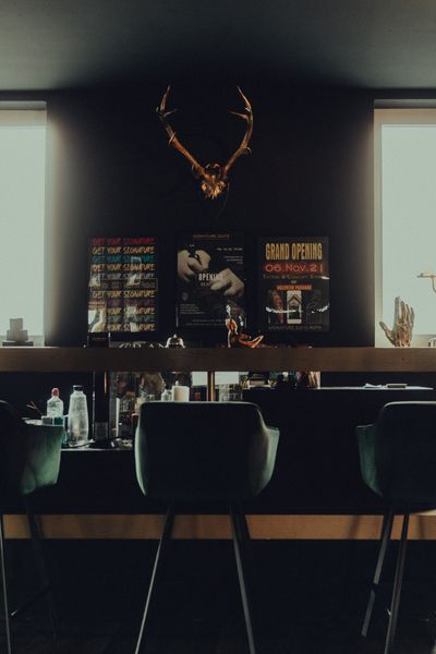The interior of No Regrets Tattoo, a stylish parlor with antlers and grand opening posters