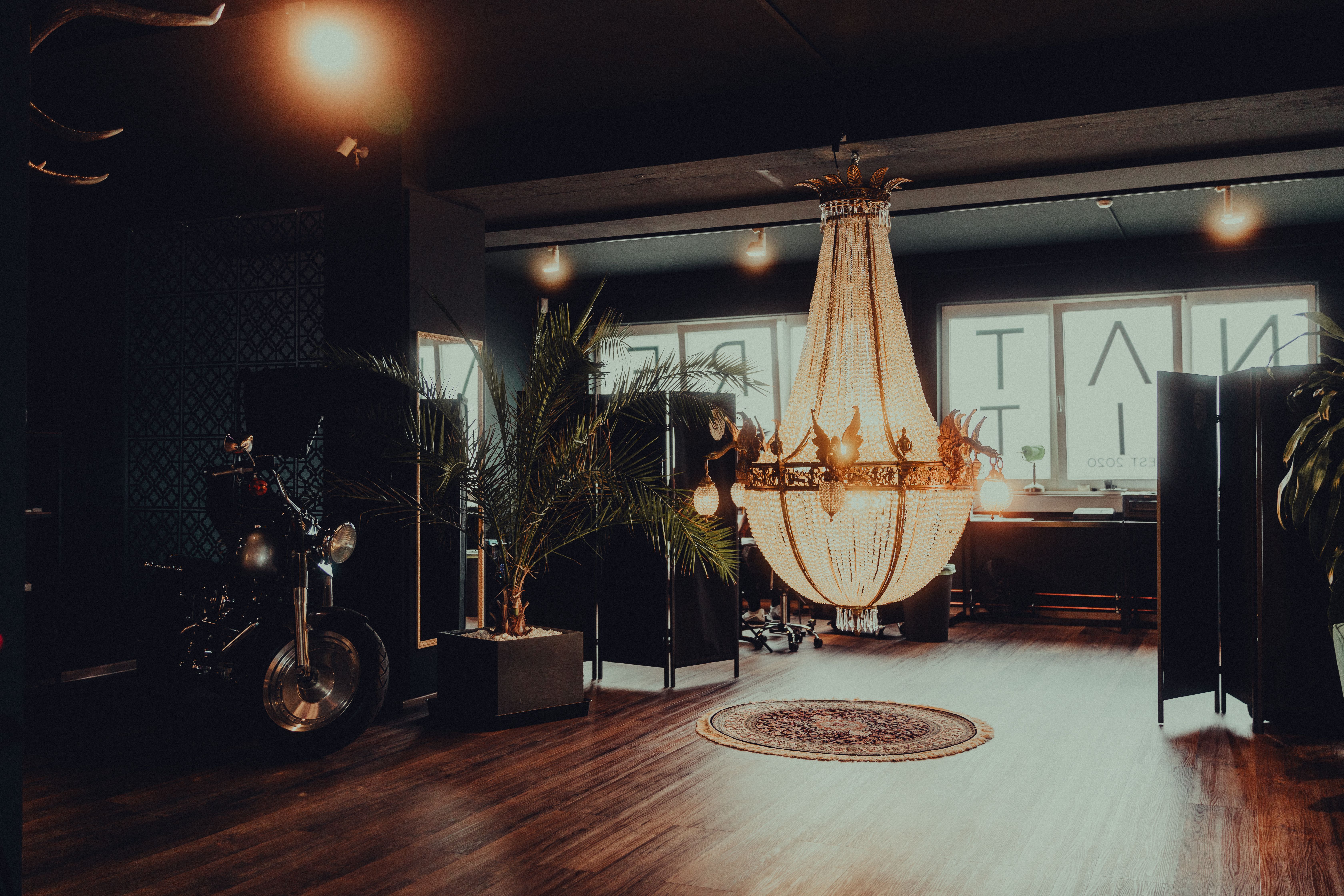 Luxurious tattoo studio interior in Keltern, Germany featuring a grand chandelier and modern decor.