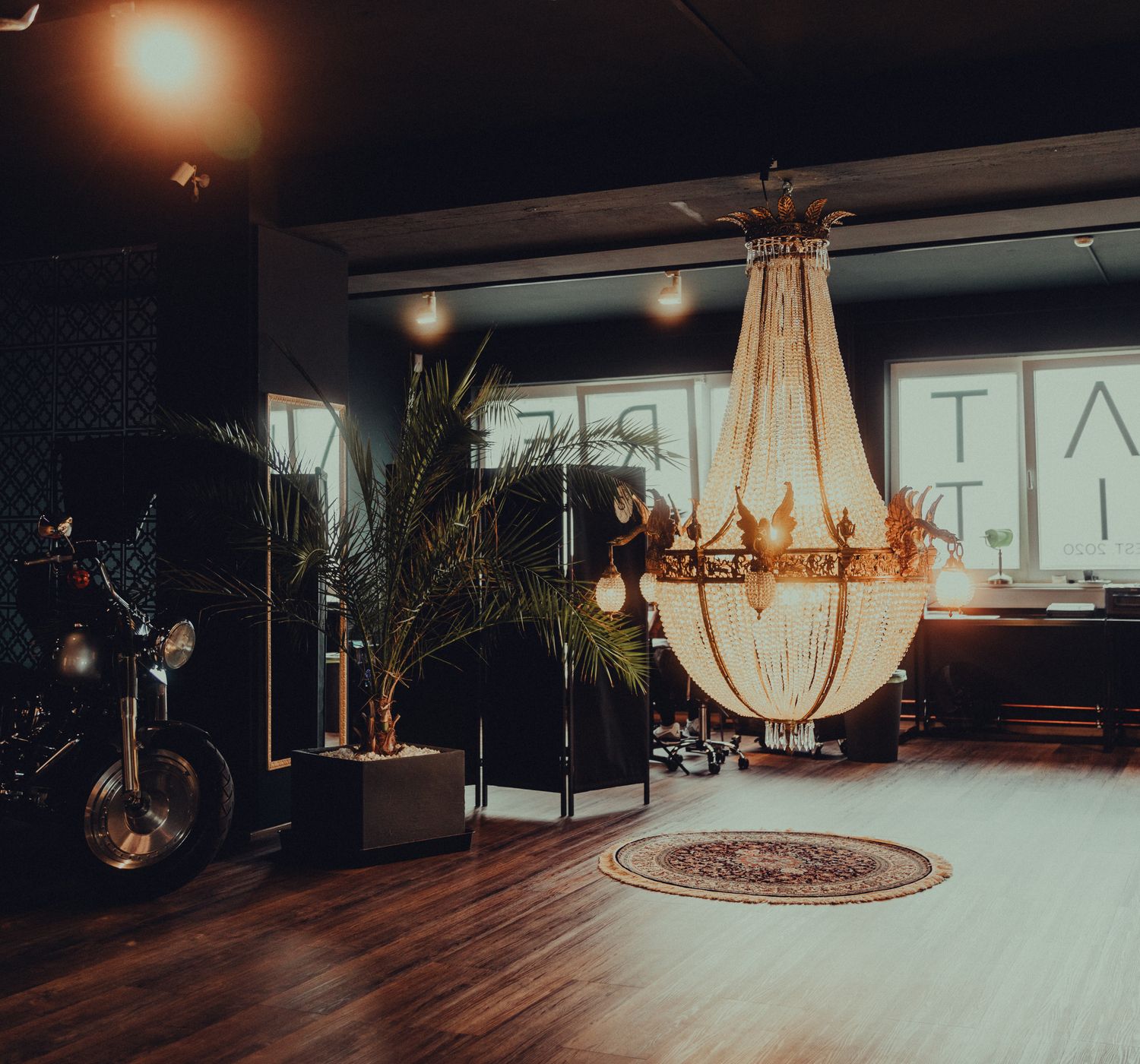 Dim tattoo studio interior with warm fixtures and a private working bench.