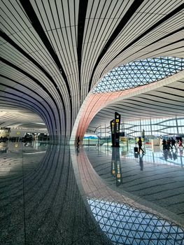Interior view of Beijing Daxing Airport showcasing its modern architectural design and spacious layout.