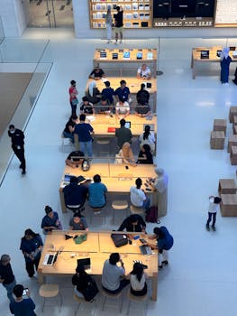 A dynamic interior view of a tech store with people engaging in Kuala Lumpur mall.