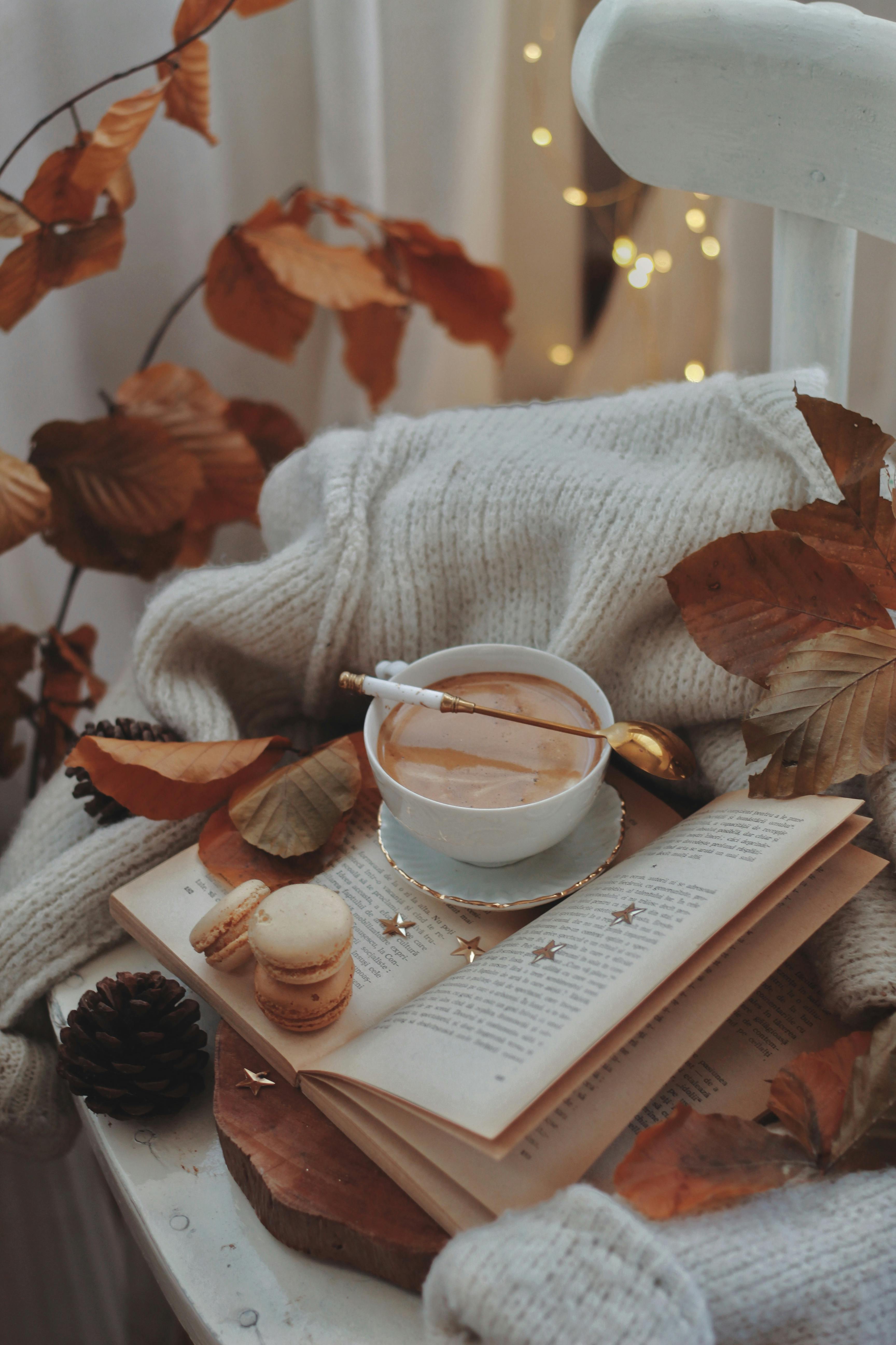 cozy autumn scene with coffee and macarons