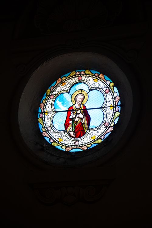 Free Colorful stained glass depicting a religious figure in a church. Stock Photo