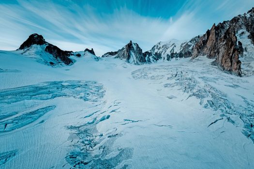 Breathtaking view of a snow-capped mountain range under a clear blue sky, perfect for nature lovers.
