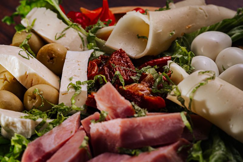 antipasto platter with olives, cheese, and cured meat