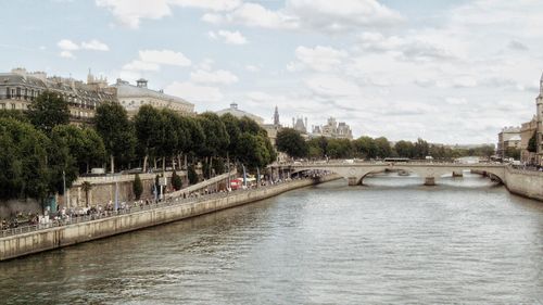 Free A picturesque shot of the Seine River with Parisian architecture and bridge. Stock Photo