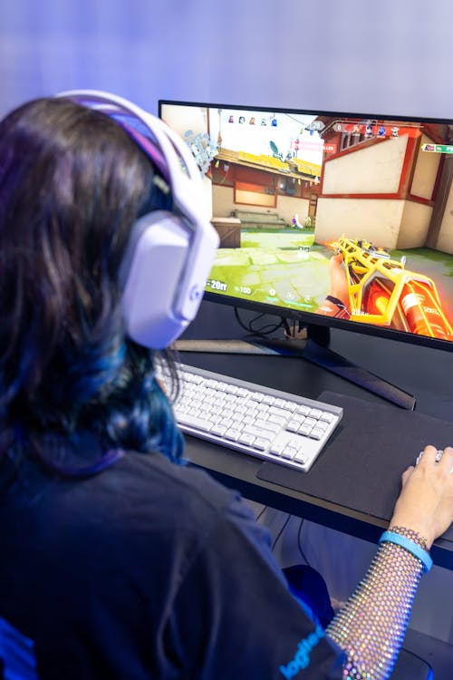 A Person Playing a Video Game in a Computer · Free Stock Photo
