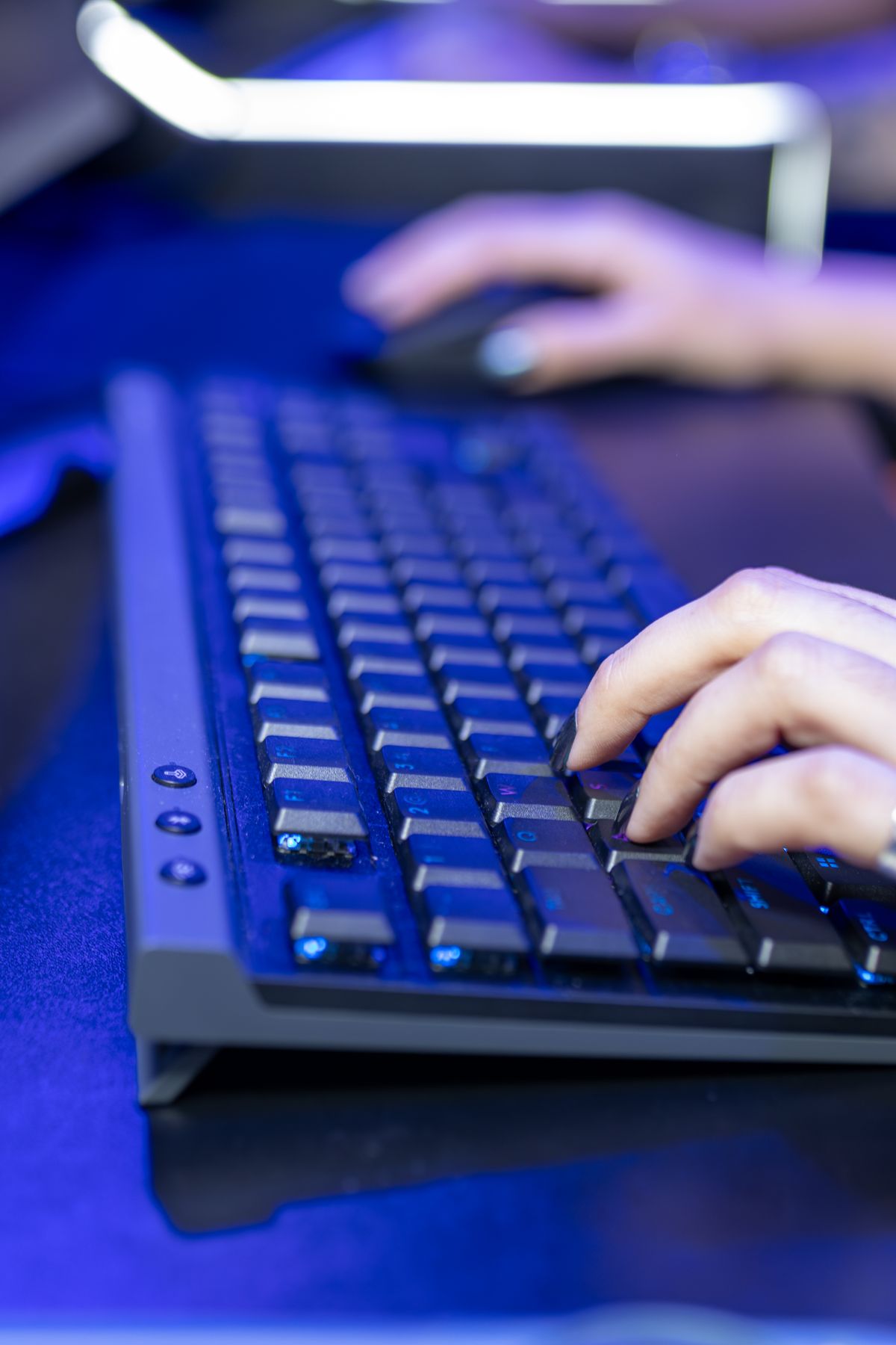 Close-up of hands typing on a keyboard representing faceless online income