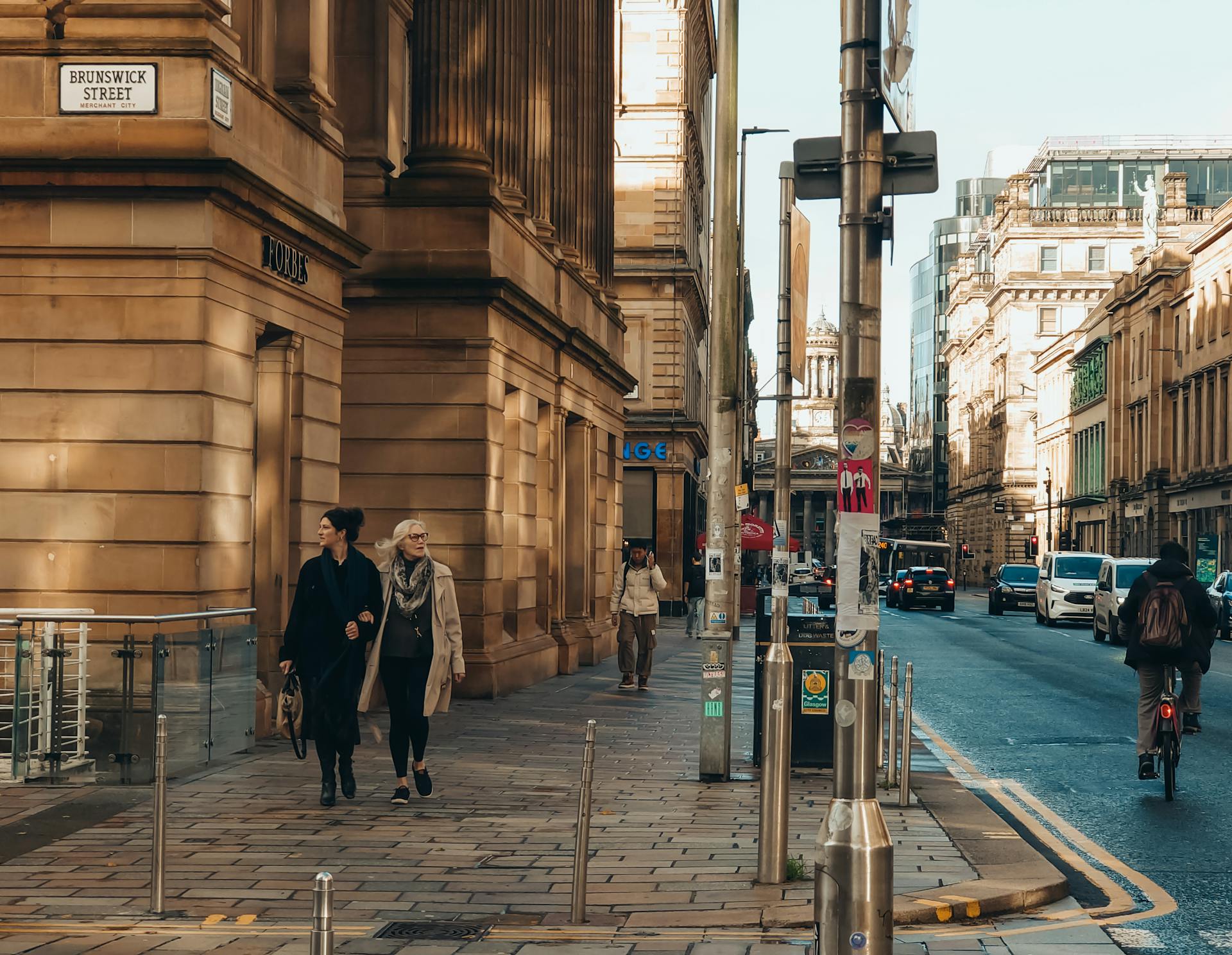 A lively street view in Glasgow's Brunswick Street featuring pedestrians and urban architecture.