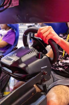 Close-up of a sim racing setup featuring a TrueForce steering wheel, showcasing immersive gameplay.