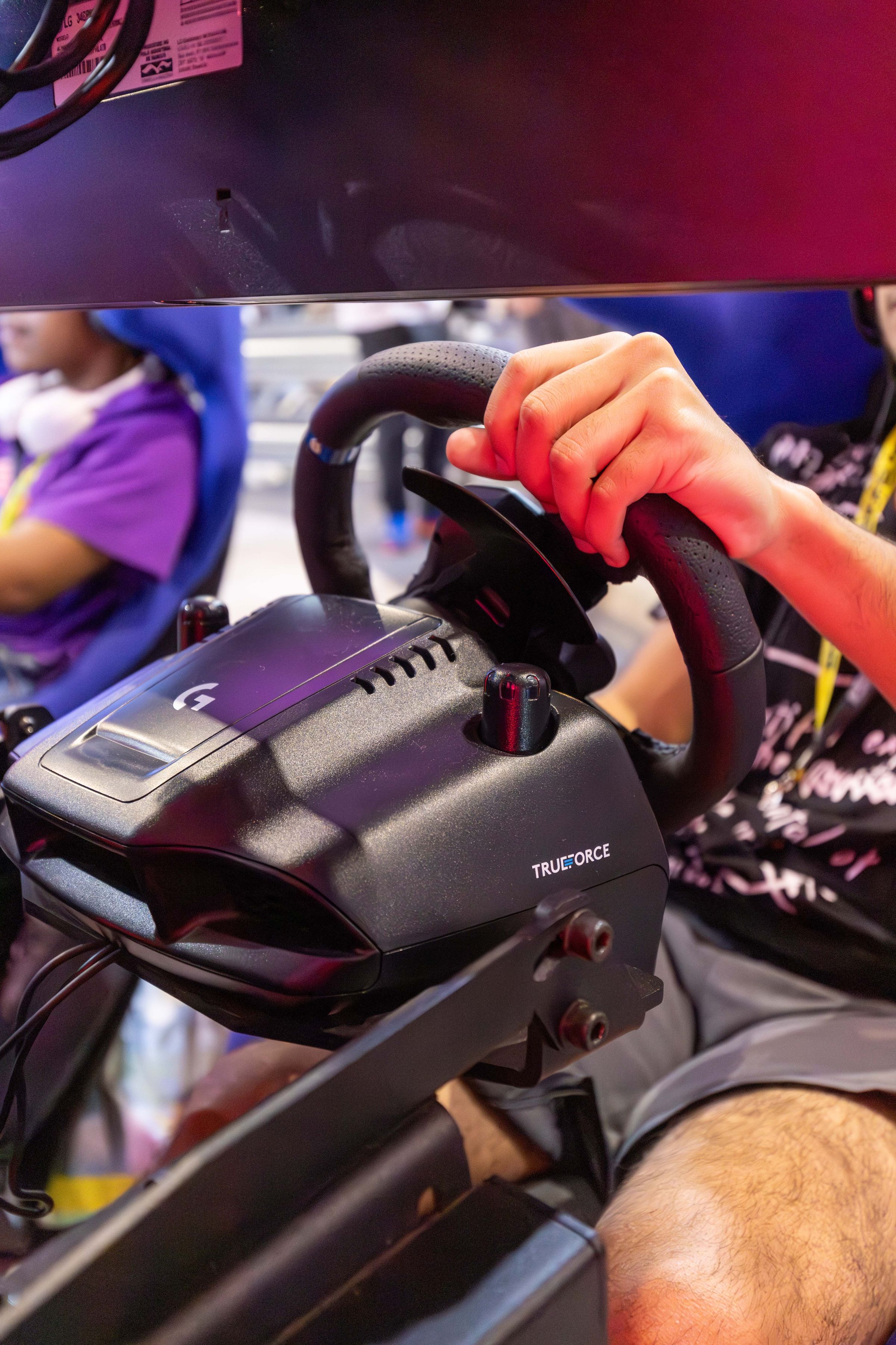 Close view of a sim racing wheel in an immersive gaming setup