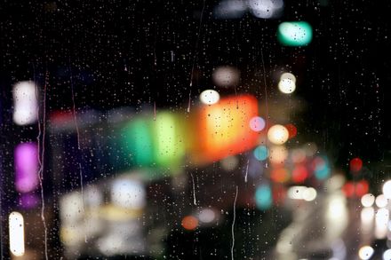 Blurred coloured city lights through a rain-covered window — photo by dp singh Bhullar on Pexels