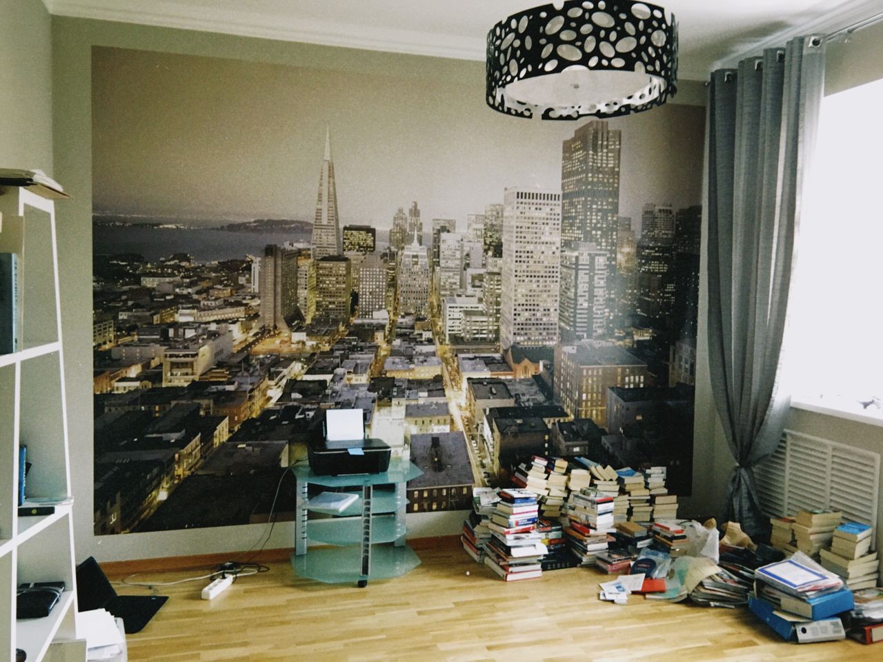 room interior with a large san francisco skyline wallpaper and stacks