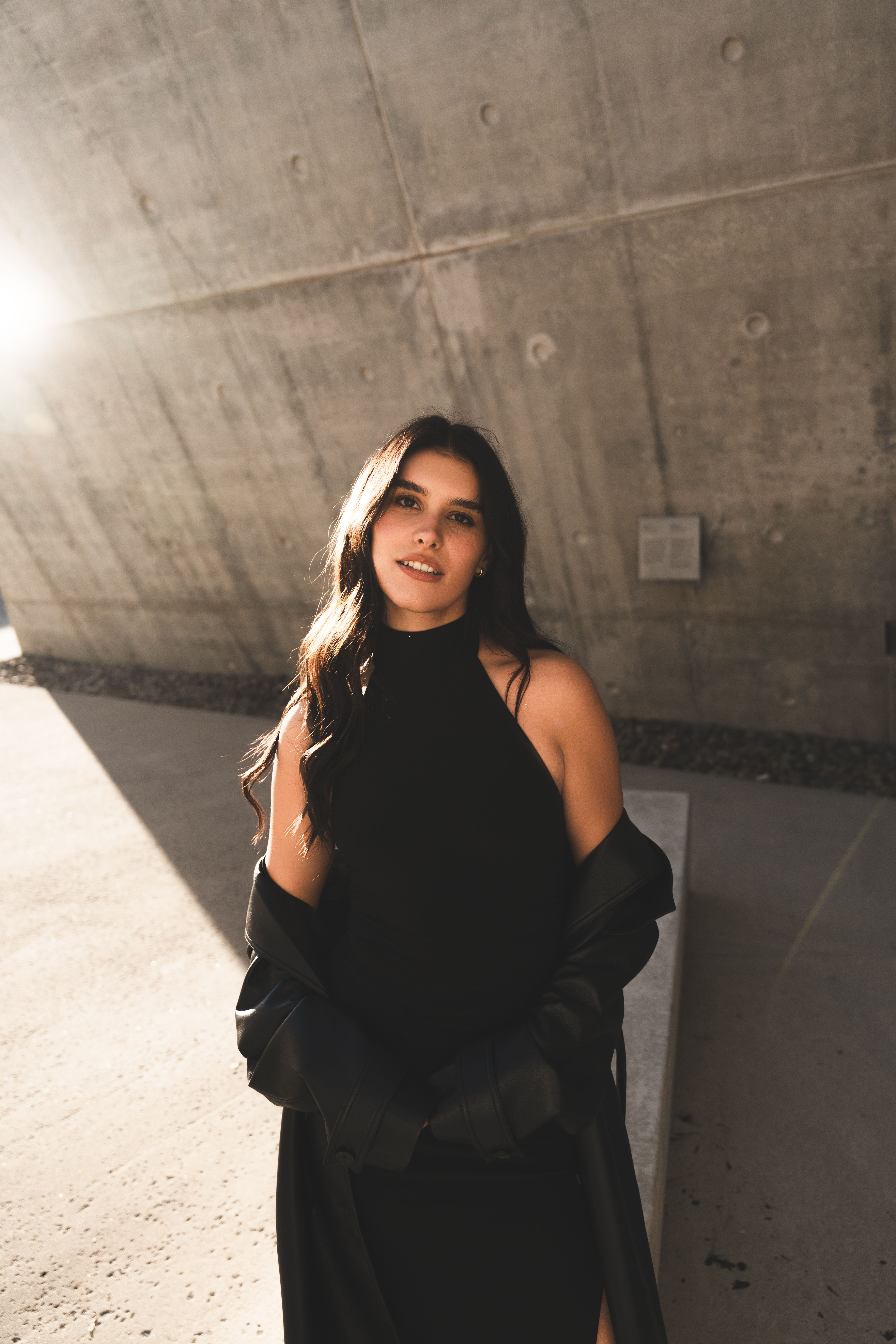 Stylish Woman in Black Dress in Urban Setting · Free Stock Photo