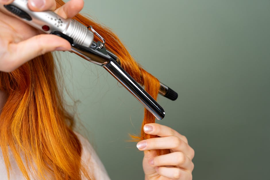 Woman using curling iron on I-tip extensions with proper technique - itip extensions care