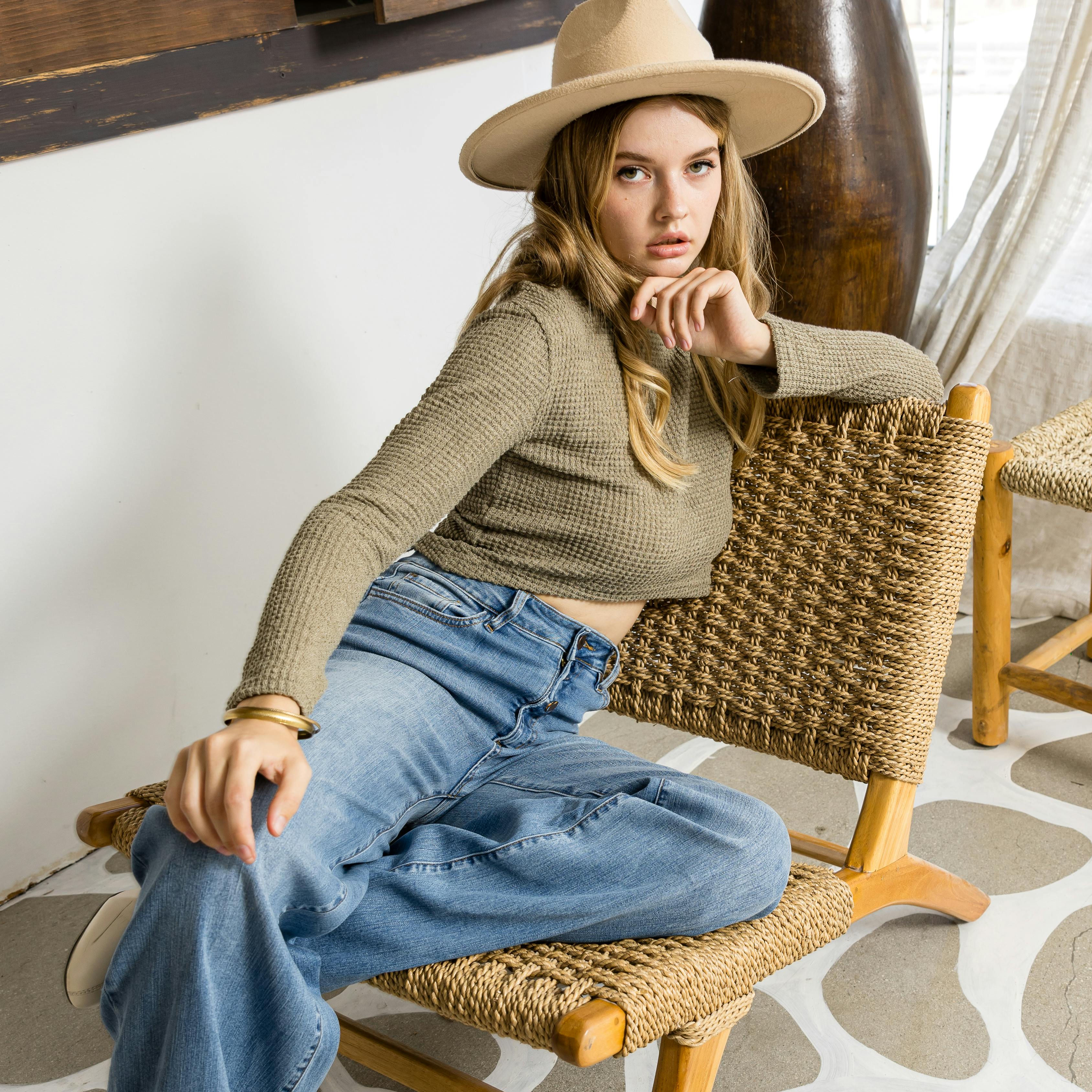 Stylish Woman Relaxing on Woven Chair Indoors