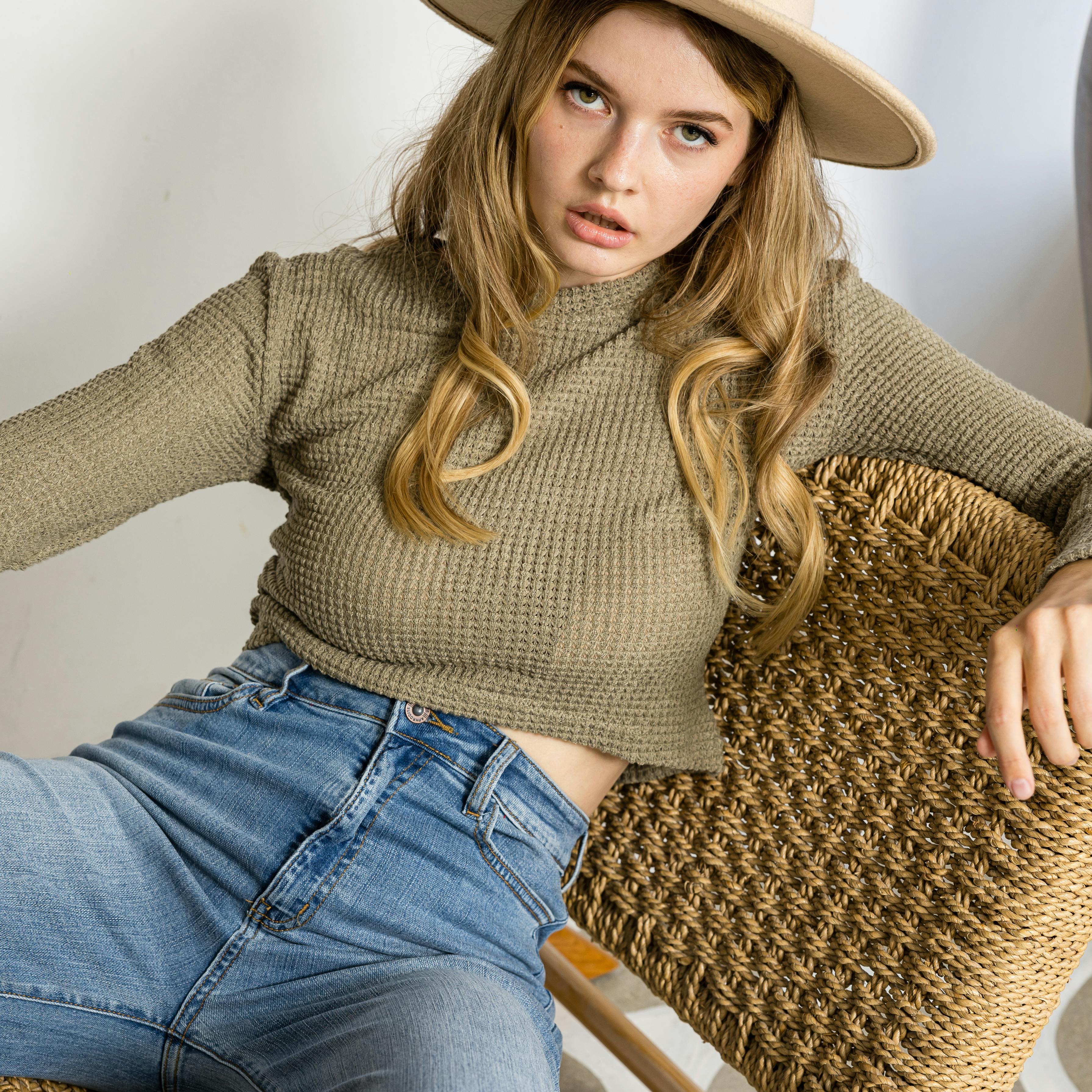 Young woman in casual outfit sitting on chair