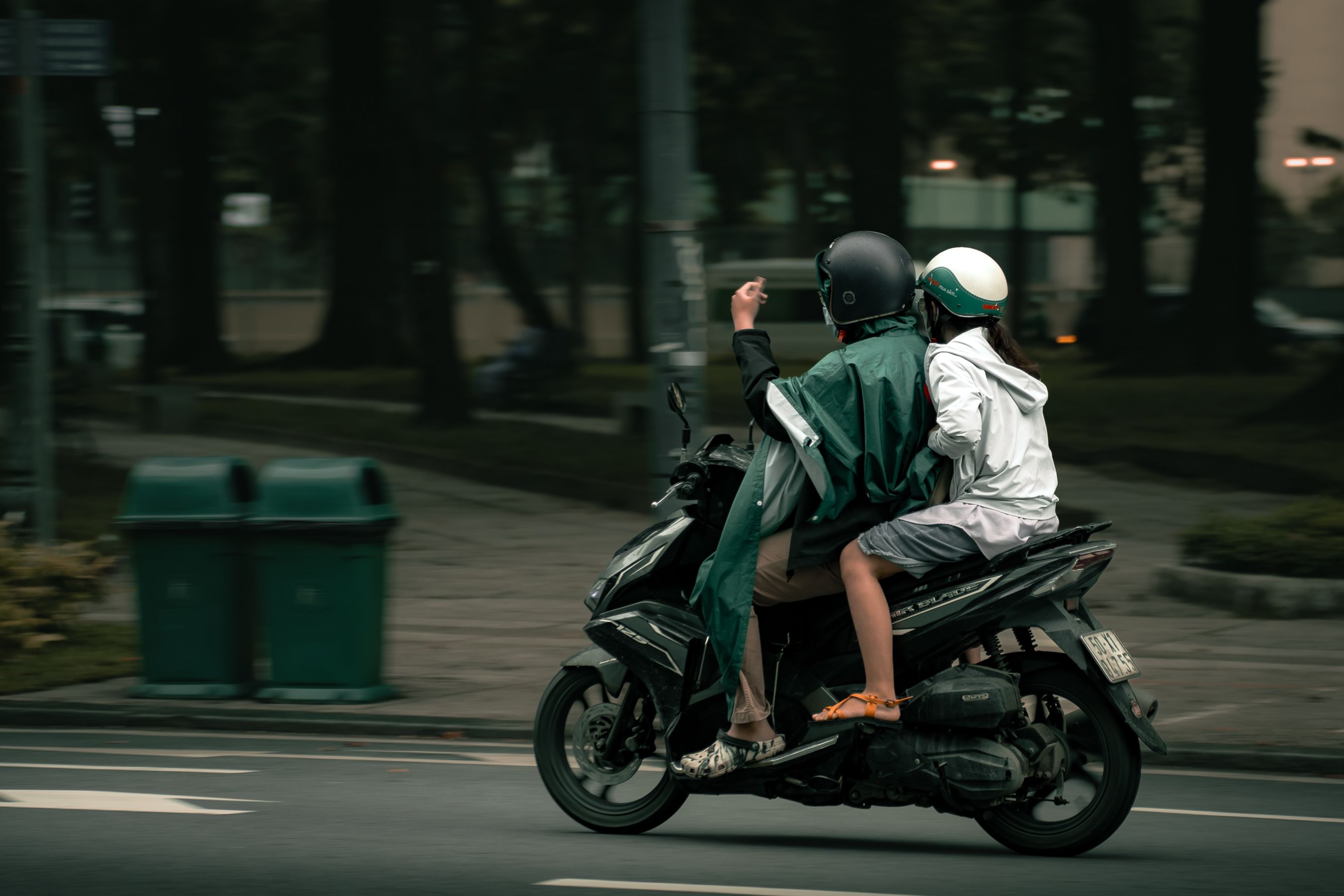 Two People Riding a Scooter on City Street · Free Stock Photo