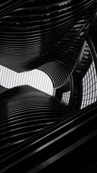 Abstract view of modern architectural curves and geometric patterns in black and white.