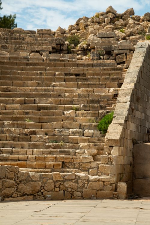 Free Close-up view of ancient stone amphitheater steps under a bright blue sky. Stock Photo