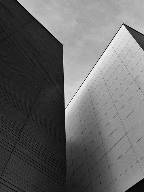 Free Stylish black and white image of geometric architectural structures viewed from below. Stock Photo