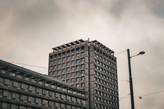 A grayscale image showcasing a modern concrete building in Oslo, capturing urban architecture.