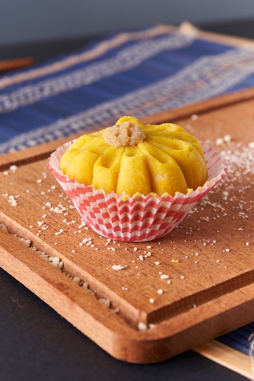 Free Colorful dessert in a cupcake liner on a rustic wooden board, perfect for sweet treat enthusiasts. Stock Photo