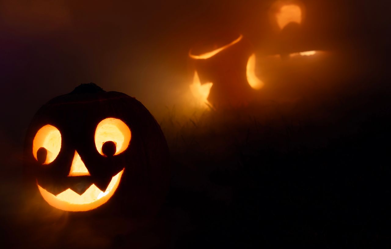 eerie jack o lanterns glowing in the fog creating a spooky halloween a