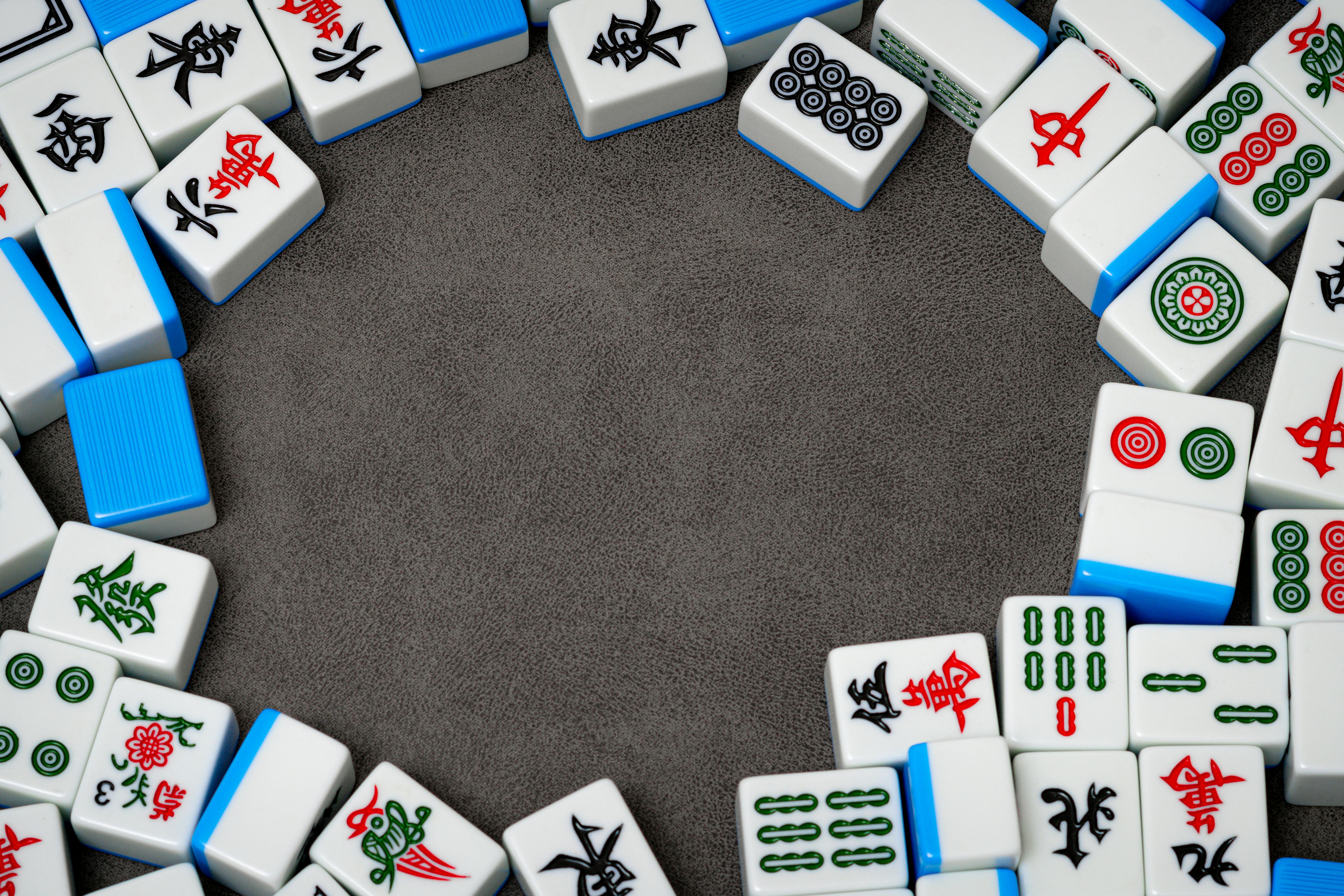 mahjong tiles arranged on a gray surface