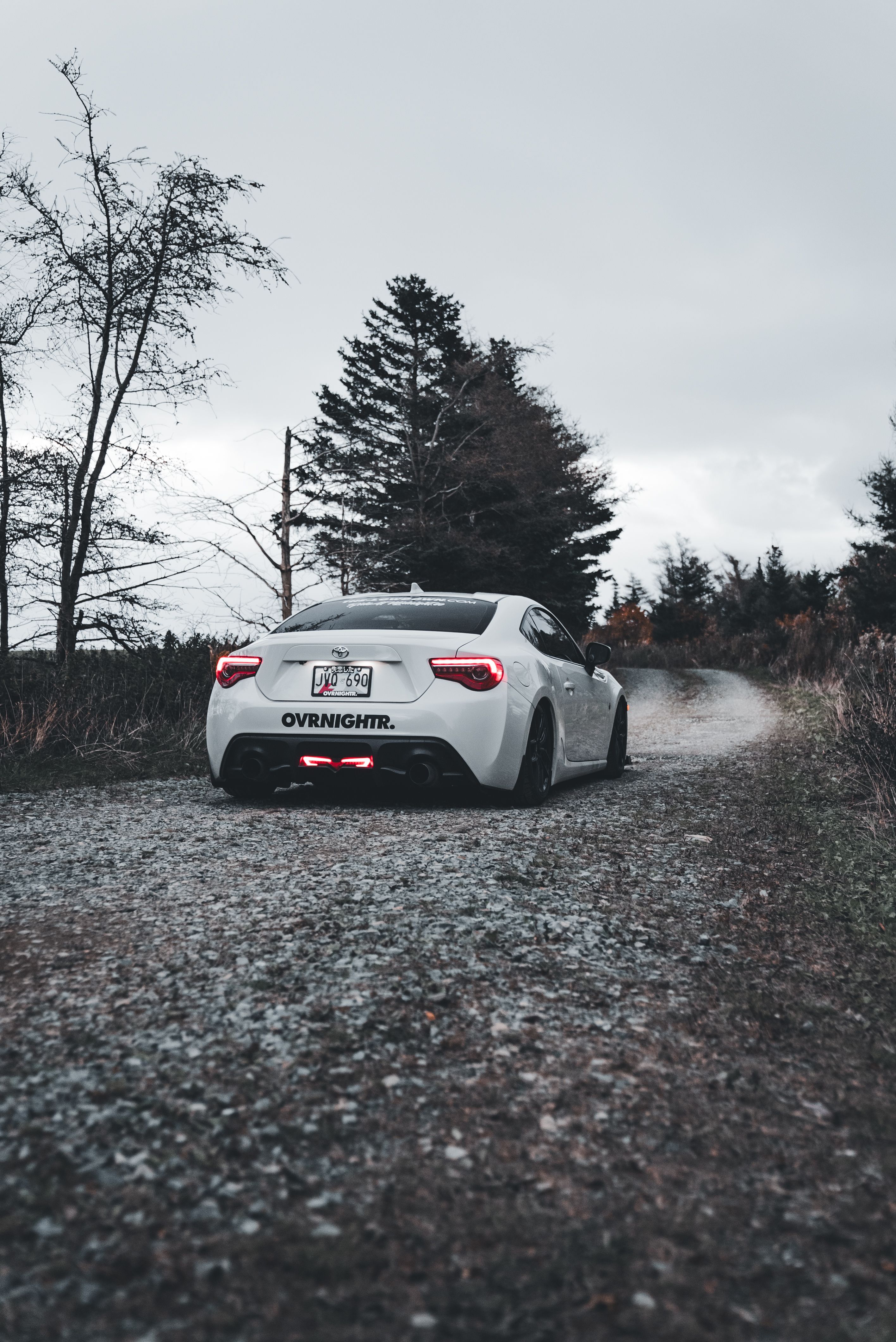 Sleek White Sports Car on Scenic Country Road · Free Stock Photo
