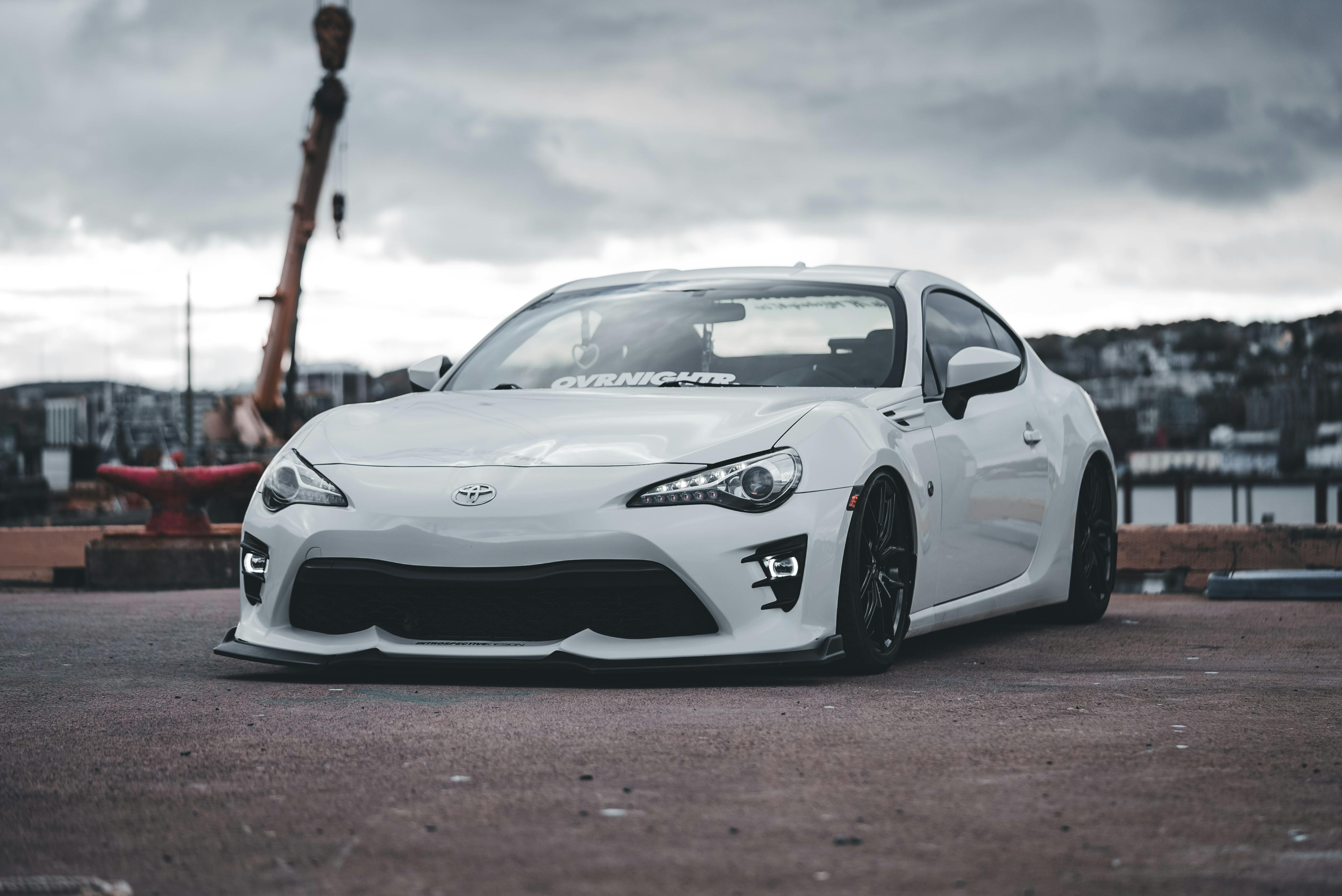 Sleek White Sports Car on Urban Road · Free Stock Photo