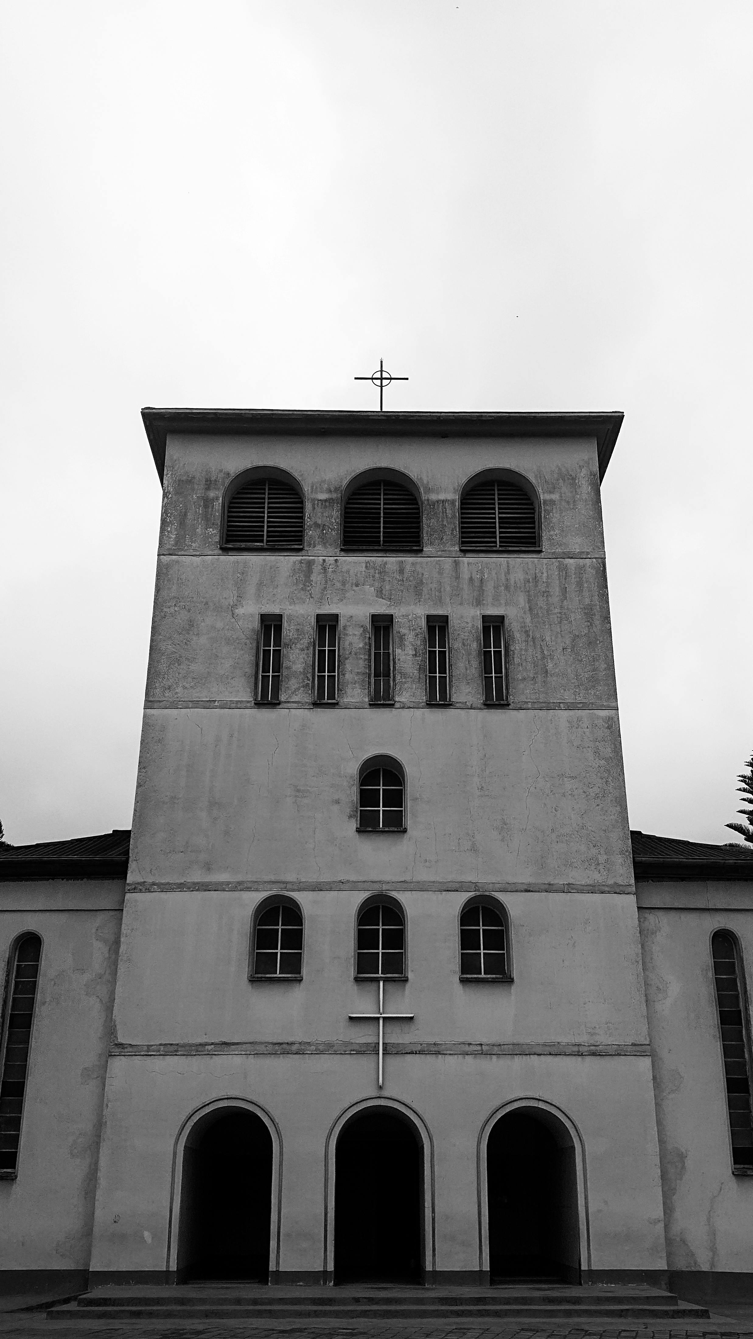 Monochrome photo of a historic church building showcasing architectural design in Uwemba, Tanzania.