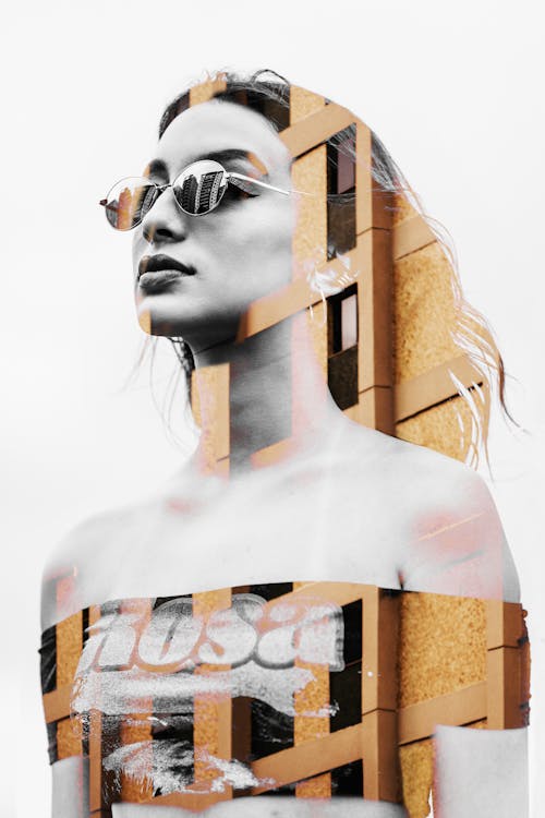 Free A Woman Wearing Sunglasses Pasted On A Building Wall Stock Photo